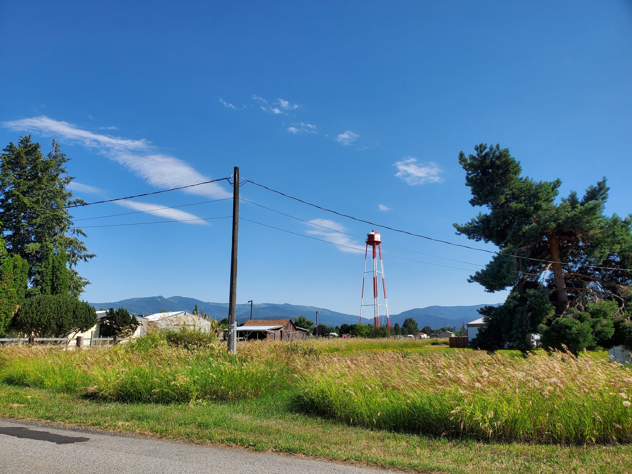 Water tower in country field.