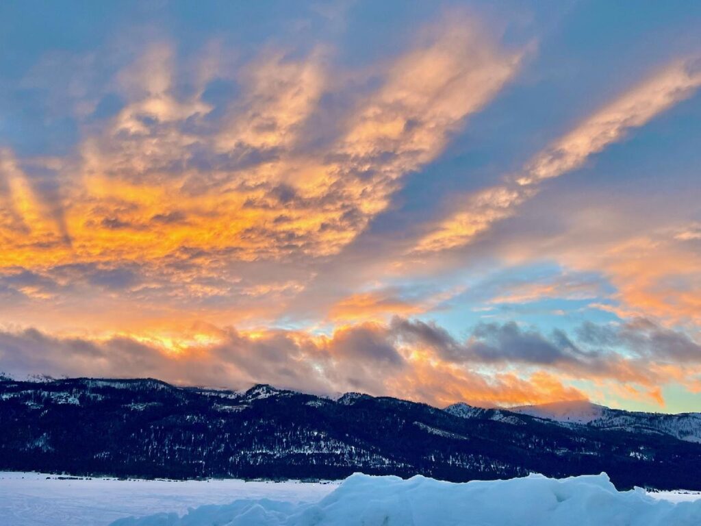 Sunrise over mountains with clouds.